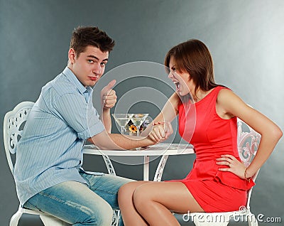 Young aggressive woman winning fighting in arm-wrestling Stock Photo