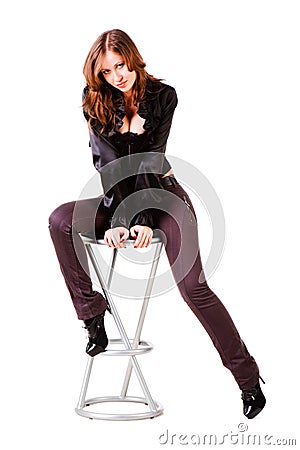 Young alluring girl in black on chair Stock Photo