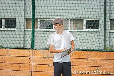 Young, ambitious coach instructs his players on what to do on the field. Coaching games from behind the line. Mentality and crisis Stock Photo