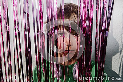 Young American boy wearing headphones near the purple confetti tapes - the concept of DJing Stock Photo