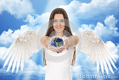 Young angel woman holding Earth in hands with clouds Stock Photo