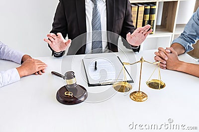Young angry couple arguing telling their problems in the courthouse to getting divorced or premarital agreement in lawyers office Stock Photo