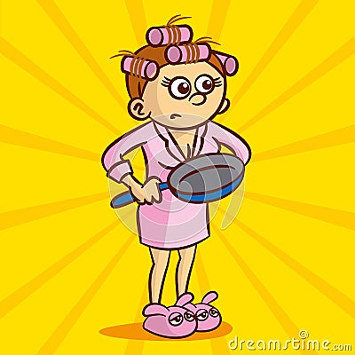 Young angry housewife in hair curlers and a dressing gown holding a frying pan Stock Photo