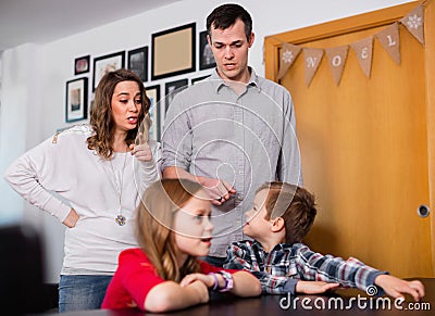 Young parents lecturing their children for bad behavior at home Stock Photo