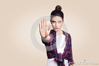 Young annoyed woman with bad attitude making stop gesture with her palm outward, saying no, expressing denial or restriction. Stock Photo