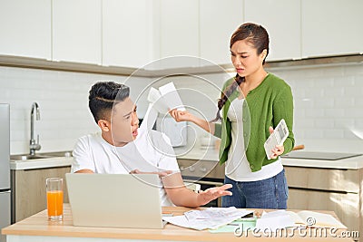 Young anxious couple quarrels by consulting their bank account Stock Photo