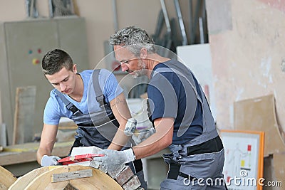 Young apprentice with professional brick layer Stock Photo