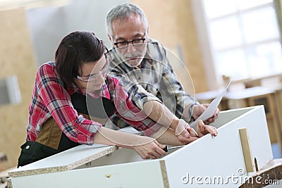 Young apprentice with senior craftsman of carpentry Stock Photo