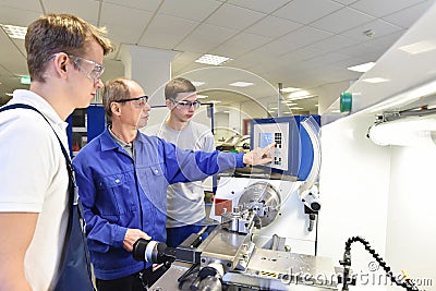 Young apprentices in technical vocational training are taught by Stock Photo