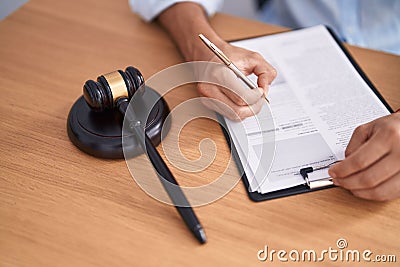 Young arab man judge writing contract at street Stock Photo