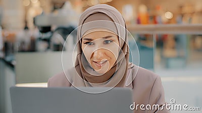 Young arab sorrowful woman in hijab reading message on laptop gets bad news denied bank loan job dismissal bankruptcy Stock Photo