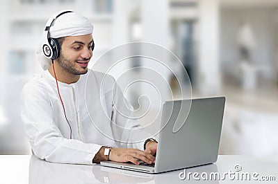 Young Arabian businessman working on his notebook Stock Photo