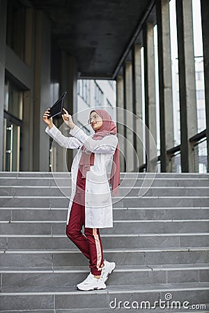 Young Arabian muslim doctor examining skull x-ray film of patient outdoors Stock Photo