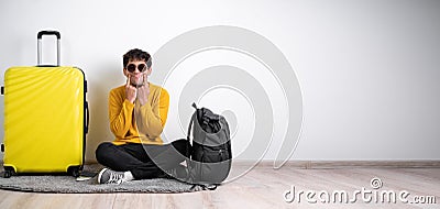 Young arabic traveler man wearing casual sweater sitting mith yellow suticase over white background Smiling with open Stock Photo