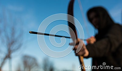 Young archer holding hes traditional hungarian bow, shallow depth of field, space for text Stock Photo