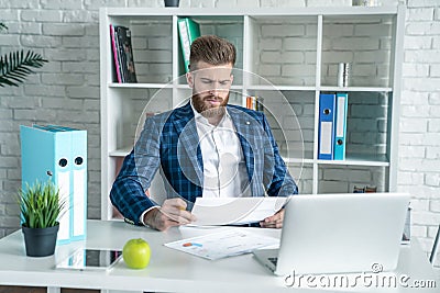 Young architect work project. Photo of bearded man working with new startup project in modern loft office. Generic design notebook Stock Photo