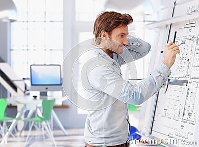 Young architect working at drawing board Stock Photo