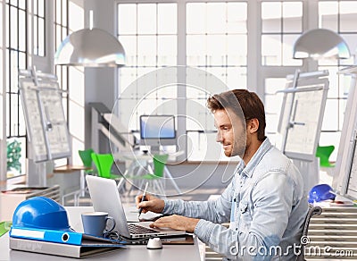 Young architect working at office desk Stock Photo