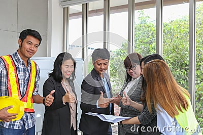 Young architectural team at work. Office worker viewing document in meeting room. Engineer and business team working on project at Stock Photo