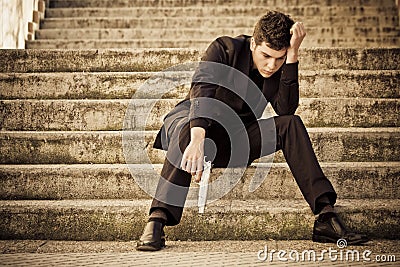 Young armed man on stairs Stock Photo