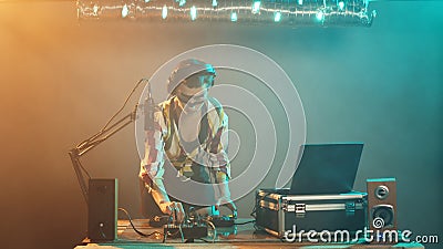 Young artist mixing with turntables on stage Stock Photo