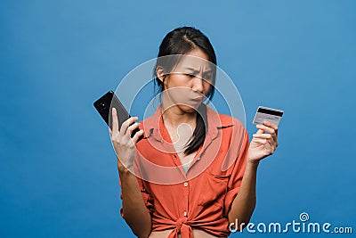 Young Asia lady using phone and credit bank card with negative expression, excited screaming, cry emotional angry in casual cloth Stock Photo
