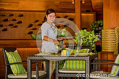 Young asian beautiful waitress serving table in the restaurant Editorial Stock Photo
