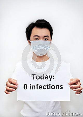 Young Asian boy holding a paper with 0 infections notice Stock Photo