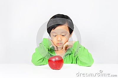 Young Asian boy reluctant to eat healthy food Stock Photo