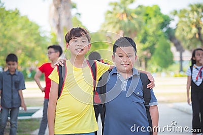 Boys friend standing in park and smiling at camera Stock Photo