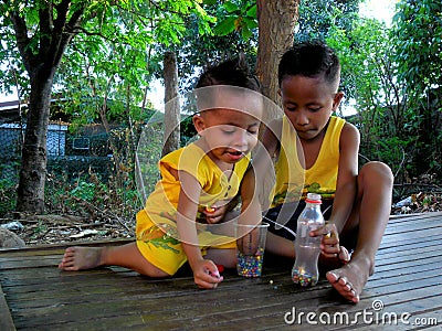 Young asian boys playing under a tree Editorial Stock Photo