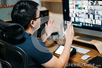 Young asian business man using computer for a online business meeting with his colleagues about plan in video conference. back Stock Photo