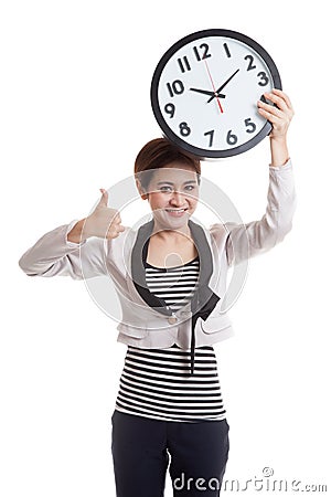 Young Asian business woman thumbs up with a clock. Stock Photo