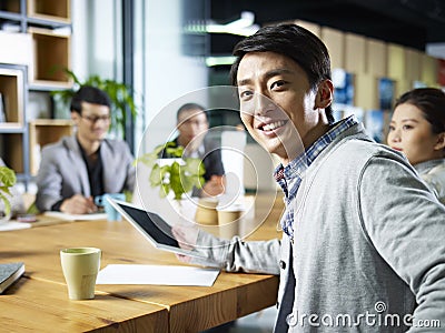 Young asian businessman looking at camera Stock Photo