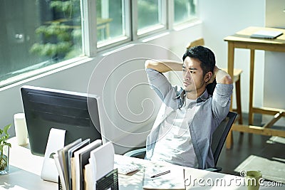 Young asian businessman thinking in office Stock Photo