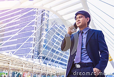 A young Asian businessman in town. A man use smartphone. Stock Photo