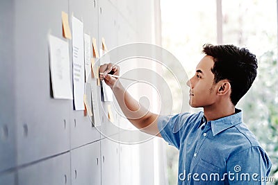 Young Asian Businessman Working in Office Meeting Room. Man Analysing Data Plans and Project Stock Photo