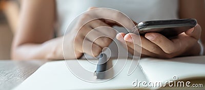 Young Asian Businesswoman using mobile phone in office, woman sitting and hand touching screen on cellphone. Smart business and Stock Photo