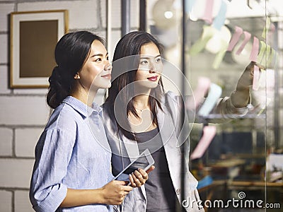 Young asian businesswomen discussing business plan in office Stock Photo