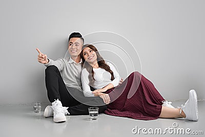 Young asian couple sitting together on floors at home Stock Photo