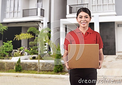 Young asian courier woman delivering package Stock Photo