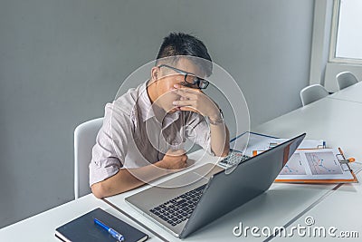 Young Asian employee feel tired and frustrated with job Stock Photo