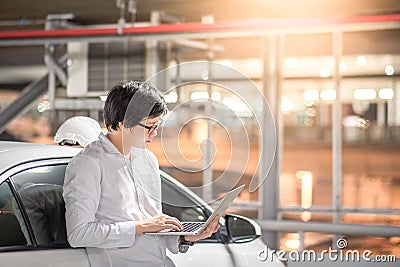 Young Asian mechanical engineer working with laptop Stock Photo