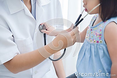 Female Doctor examining a little girl. Stock Photo