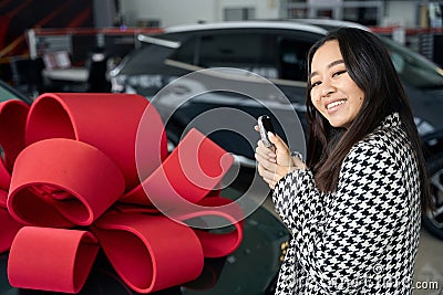 Young asian female stands with car keys Stock Photo