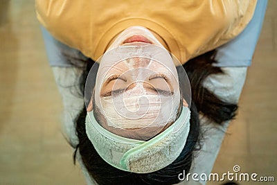 Young Asian female teenager getting her acne and facial treatment Stock Photo