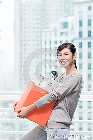 Young asian girl carrying removal crate Stock Photo