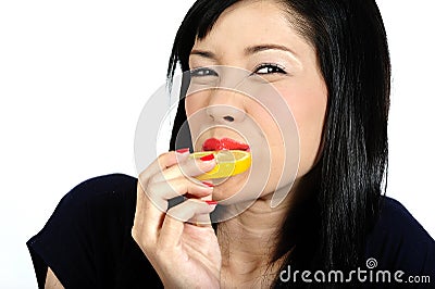 Young asian girl eating lemon Stock Photo