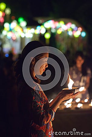 Asian woman light the candle to pray in Loi Krathong festival in Thailand Editorial Stock Photo