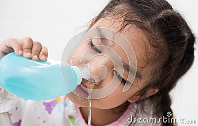 Young Asian girl Sick kids cleaning nose with Nasal irrigation Stock Photo